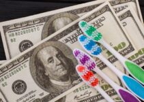 Close up of money and toothbrush. American dollars and colorful toothbrush.
